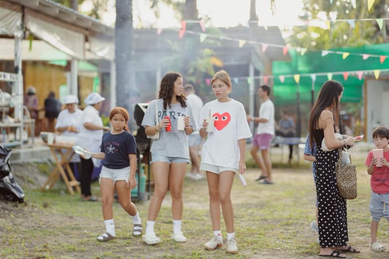 Children walking between the stalls with their drinks
