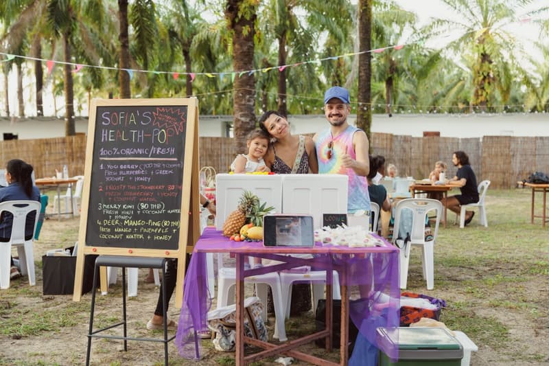 A family at their fresh fruit drinks stall