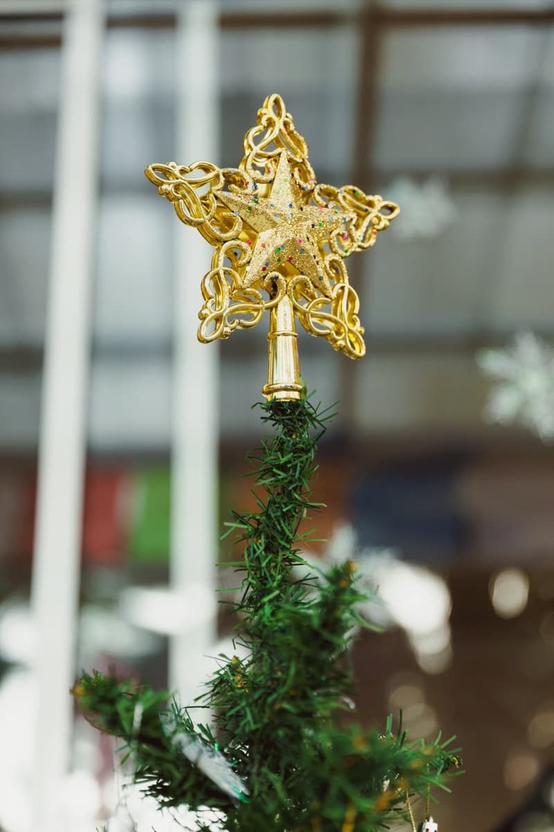 A gold star on top of the Christmas tree