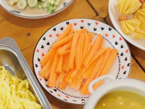 Carrot sticks and fruit laid out for snack