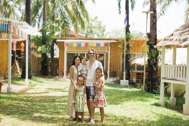 Marc and Nutthanit Schwyn with their three children on the school lawn