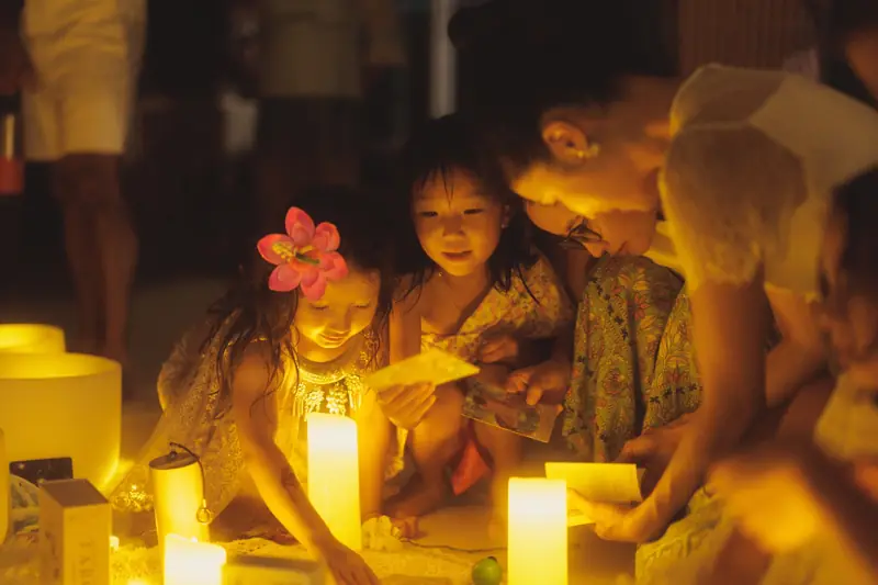 Children lit by candles on the Loy Krathong evening