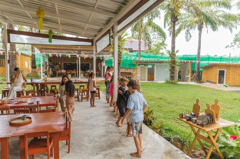 Children lining up at the open-air dining pavilion